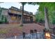 Back of the home with a stone foundation, balcony, screened porch and a fire pit with comfortable seating at 223 Old Rome Rd, Kingston, GA 30145