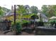 Expansive home exterior with decks, stone chimney, professionally landscaped yard and porch with railings at 223 Old Rome Rd, Kingston, GA 30145