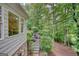 Exterior view of home, showcasing the deck with wicker furniture and stairs to backyard at 223 Old Rome Rd, Kingston, GA 30145
