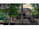 Back exterior of home with a spacious deck featuring steps, and a wooded backdrop, perfect for outdoor living at 223 Old Rome Rd, Kingston, GA 30145