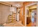Unfinished basement with water heater and doorway to finished part of basement at 223 Old Rome Rd, Kingston, GA 30145
