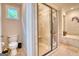 Neutral bathroom featuring tiled shower with glass surround, toilet, and soaking tub at 223 Old Rome Rd, Kingston, GA 30145