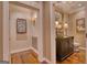 Hallway featuring the entrance to a bathroom with beautiful wood floors and stylish decor at 223 Old Rome Rd, Kingston, GA 30145