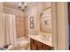 Bathroom featuring tiled shower, vanity with sink, and decorative wall mirror at 223 Old Rome Rd, Kingston, GA 30145