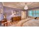 Elegant bedroom with chandelier, hardwood floors, and custom window treatments at 223 Old Rome Rd, Kingston, GA 30145