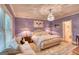 Luxurious bedroom with chandelier, custom paint, and plush seating area at 223 Old Rome Rd, Kingston, GA 30145