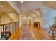 Large bonus room with wood floors, rug runner, and decorative railing at 223 Old Rome Rd, Kingston, GA 30145