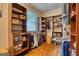 Walk-in closet featuring hardwood floors, custom built-ins, and shelving for storage at 223 Old Rome Rd, Kingston, GA 30145