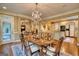 Open dining room area featuring chandelier and access to a kitchen with white cabinets at 223 Old Rome Rd, Kingston, GA 30145