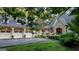 Charming home exterior featuring a stone facade, three-car garage, and lush landscaping for exceptional curb appeal at 223 Old Rome Rd, Kingston, GA 30145