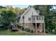 Back exterior of home featuring a stone foundation, and deck. Includes a staircase and covered porch at 223 Old Rome Rd, Kingston, GA 30145
