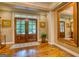Spacious foyer with hardwood floors, double doors, and a large mirror at 223 Old Rome Rd, Kingston, GA 30145