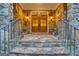 Stone front porch with iron railing, manicured landscaping, and beautiful double doors with sidelights create a welcoming entrance at 223 Old Rome Rd, Kingston, GA 30145