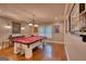 Spacious game room featuring a red felt pool table, chandelier, and stained concrete floors at 223 Old Rome Rd, Kingston, GA 30145