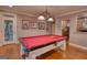 Game room showcasing a red felt pool table, stained concrete floors, and access to outdoor space at 223 Old Rome Rd, Kingston, GA 30145