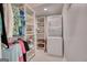 Well-organized laundry room and closet with shelving and a stacked washer and dryer unit for added convenience at 223 Old Rome Rd, Kingston, GA 30145