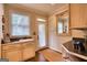 Well-lit laundry room with sink, cabinets, and access to the outdoors at 223 Old Rome Rd, Kingston, GA 30145