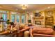 A cozy living room with comfortable leather seating, a fireplace, and access to an outdoor deck at 223 Old Rome Rd, Kingston, GA 30145
