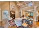 Bright and airy living room featuring a fireplace, vaulted ceilings, and a wall of windows overlooking the backyard at 223 Old Rome Rd, Kingston, GA 30145