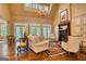 Bright and airy living room featuring a fireplace, vaulted ceilings, and a wall of windows overlooking the backyard at 223 Old Rome Rd, Kingston, GA 30145