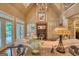 Bright and airy living room featuring a fireplace, vaulted ceilings, and a wall of windows overlooking the backyard at 223 Old Rome Rd, Kingston, GA 30145