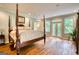 Spacious main bedroom with hardwood floors, large windows, and ensuite sunroom access at 223 Old Rome Rd, Kingston, GA 30145