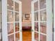Bedroom view through French doors of a large main bedroom with natural light at 223 Old Rome Rd, Kingston, GA 30145