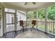Screened in porch with chairs and table and view of the side yard at 223 Old Rome Rd, Kingston, GA 30145