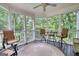 Screened in porch with chairs and table with a view of trees at 223 Old Rome Rd, Kingston, GA 30145