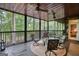 Covered porch with ceiling fans and an outdoor seating area with a view of trees at 223 Old Rome Rd, Kingston, GA 30145