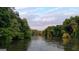Scenic river view framed by mature trees under a sky with light clouds, ideal for nature lovers at 223 Old Rome Rd, Kingston, GA 30145
