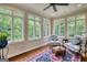 Sunroom with hardwood floors, ceiling fan, and an abundance of natural light from the large windows at 223 Old Rome Rd, Kingston, GA 30145