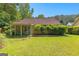The backyard has a covered patio, trimmed bushes, and green grass at 110 Long Leaf, Peachtree City, GA 30269