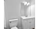 Clean bathroom featuring a vanity, toilet, and an updated mirror with modern fixtures at 110 Long Leaf, Peachtree City, GA 30269