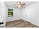 Cozy bedroom featuring wood floors, natural light from the window, and a practical ceiling fan at 110 Long Leaf, Peachtree City, GA 30269