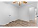 Charming bedroom featuring wood floors, ceiling fan, closet door and entrance to another room at 110 Long Leaf, Peachtree City, GA 30269