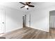 Cozy bedroom with sleek wood floors, a ceiling fan, and ample closet space for organized storage at 110 Long Leaf, Peachtree City, GA 30269
