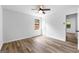 Spacious bedroom featuring wood floors, window and door allowing plenty of natural light, complemented by a ceiling fan at 110 Long Leaf, Peachtree City, GA 30269