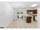 Charming eat-in kitchen with tile flooring, white appliances, and a bright breakfast area with french doors at 110 Long Leaf, Peachtree City, GA 30269