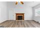 Bright living room featuring a fireplace, wood floors, and a ceiling fan at 110 Long Leaf, Peachtree City, GA 30269