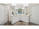The ensuite bathroom includes a double vanity with white cabinetry and lots of mirrors for an open feeling at 1979 Alcovy Shoals Blf, Lawrenceville, GA 30045