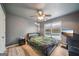 Modern bedroom with wood-look flooring, ceiling fan and large window at 1979 Alcovy Shoals Blf, Lawrenceville, GA 30045