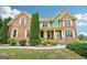 Attractive two-story brick home featuring professional landscaping and an inviting entrance at 1979 Alcovy Shoals Blf, Lawrenceville, GA 30045