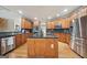 Spacious kitchen featuring granite countertops, stainless steel appliances, and custom wood cabinetry at 1979 Alcovy Shoals Blf, Lawrenceville, GA 30045