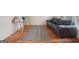 This is a cozy living area with hardwood floors, an area rug, a leather sofa and lots of natural light at 1979 Alcovy Shoals Blf, Lawrenceville, GA 30045