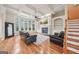 Cozy living room featuring a fireplace, built-in bookshelves, and hardwood floors at 1979 Alcovy Shoals Blf, Lawrenceville, GA 30045
