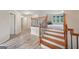 This is a view of the staircase with wood treads, a decorative banister and vinyl flooring on the lower level at 1979 Alcovy Shoals Blf, Lawrenceville, GA 30045