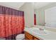 Bathroom featuring a single sink vanity, toilet, and shower with curtain at 12303 Waldrop Pl, Decatur, GA 30034