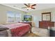 Bright bedroom with a large window, ceiling fan, and a comfortable queen-size bed at 12303 Waldrop Pl, Decatur, GA 30034