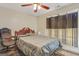 Bedroom featuring a comfortable bed, a cozy rug, a rolling office chair, and an adjacent window for natural light at 12303 Waldrop Pl, Decatur, GA 30034